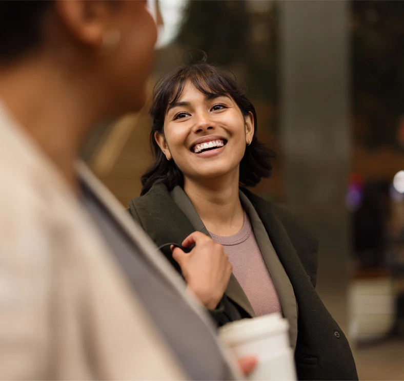 Person having a friendly conversation, representing personalized checking account services and everyday banking solutions.