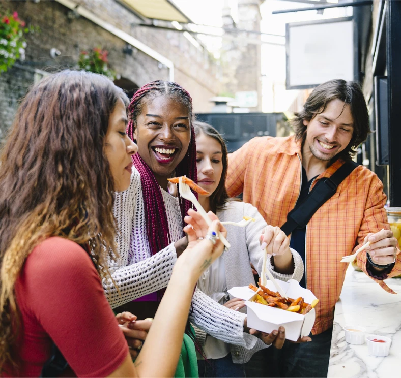 Group of people gathering together and sharing a meal, representing the connections, resources, and personalized guidance available through Connect Five.