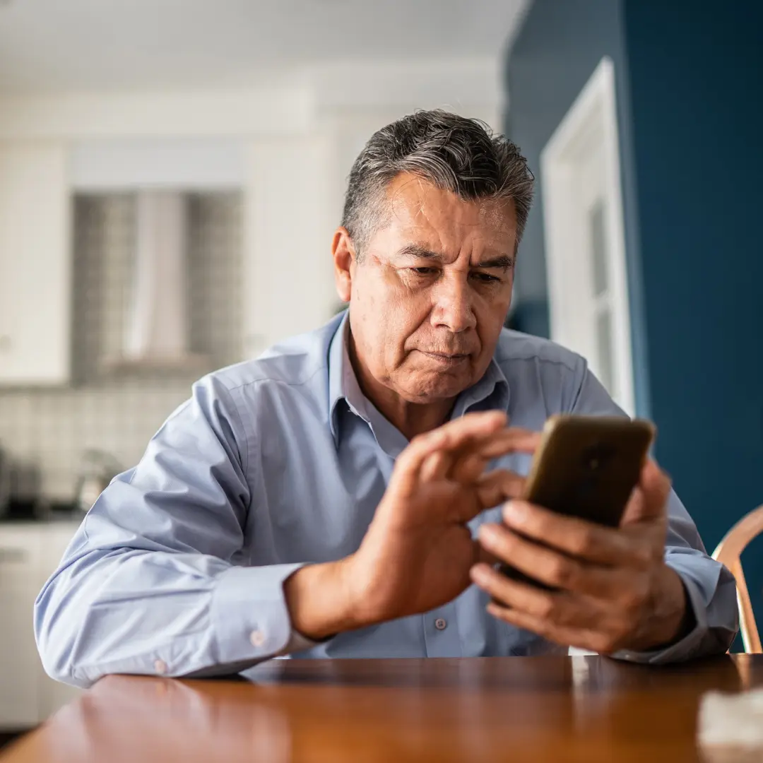 Concerned looking man using his mobile phone